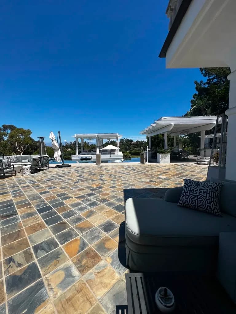 Outdoor patio with pergola and pool by Top Tech Builders