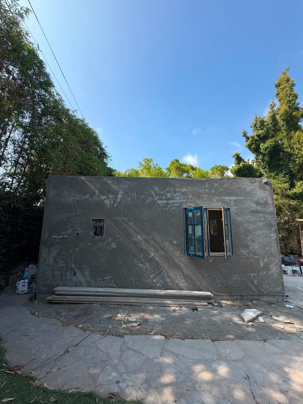 Exterior stucco wall with window installation by Top Tech Builders