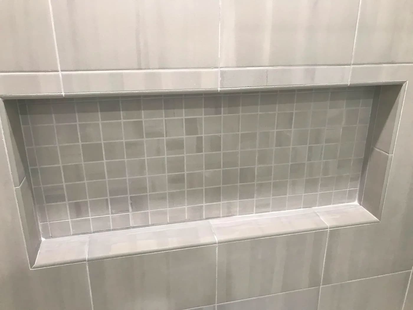 Tiled shower niche by Top Tech Builders