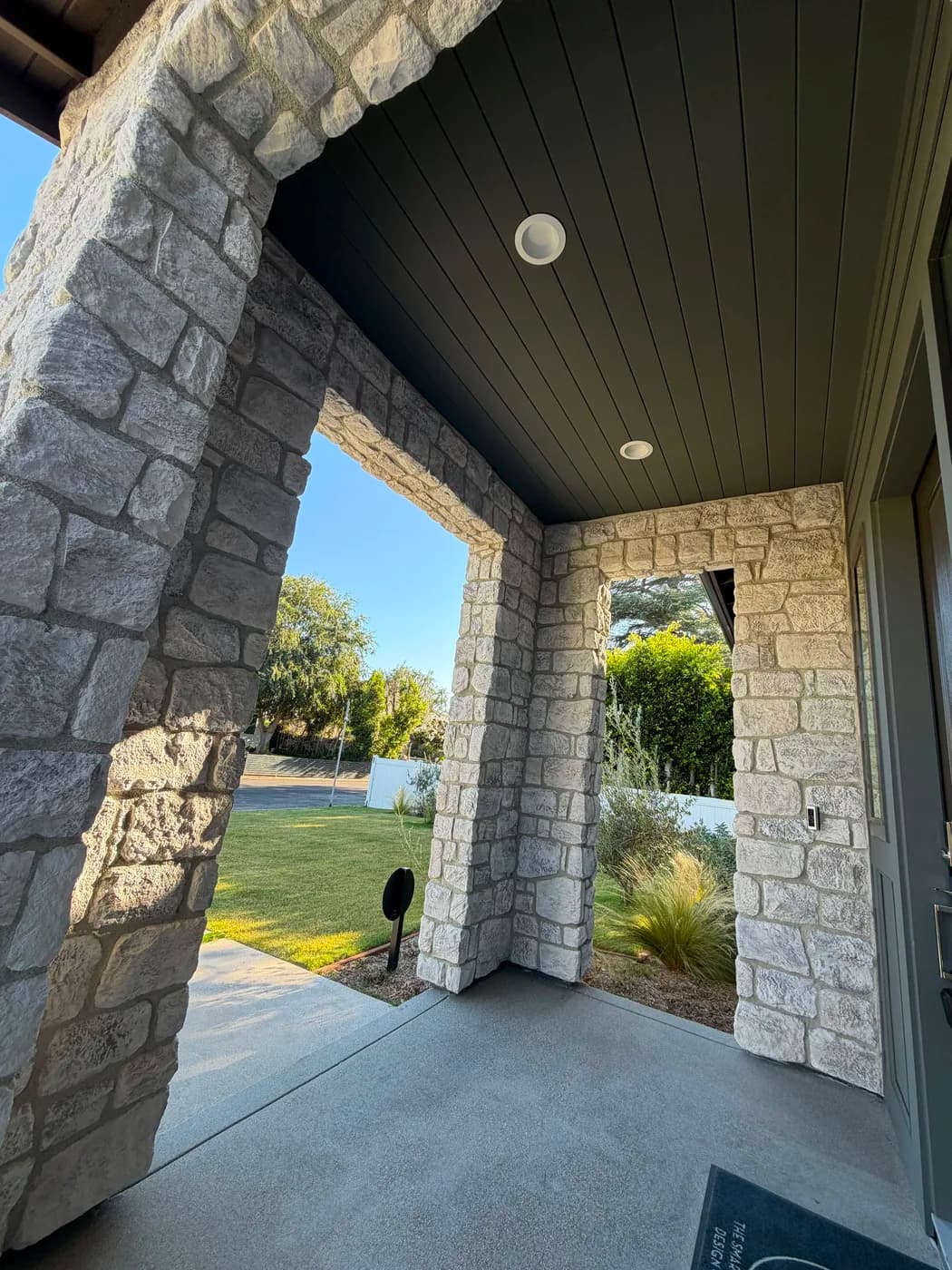 Stone veneer entry porch by Top Tech Builders