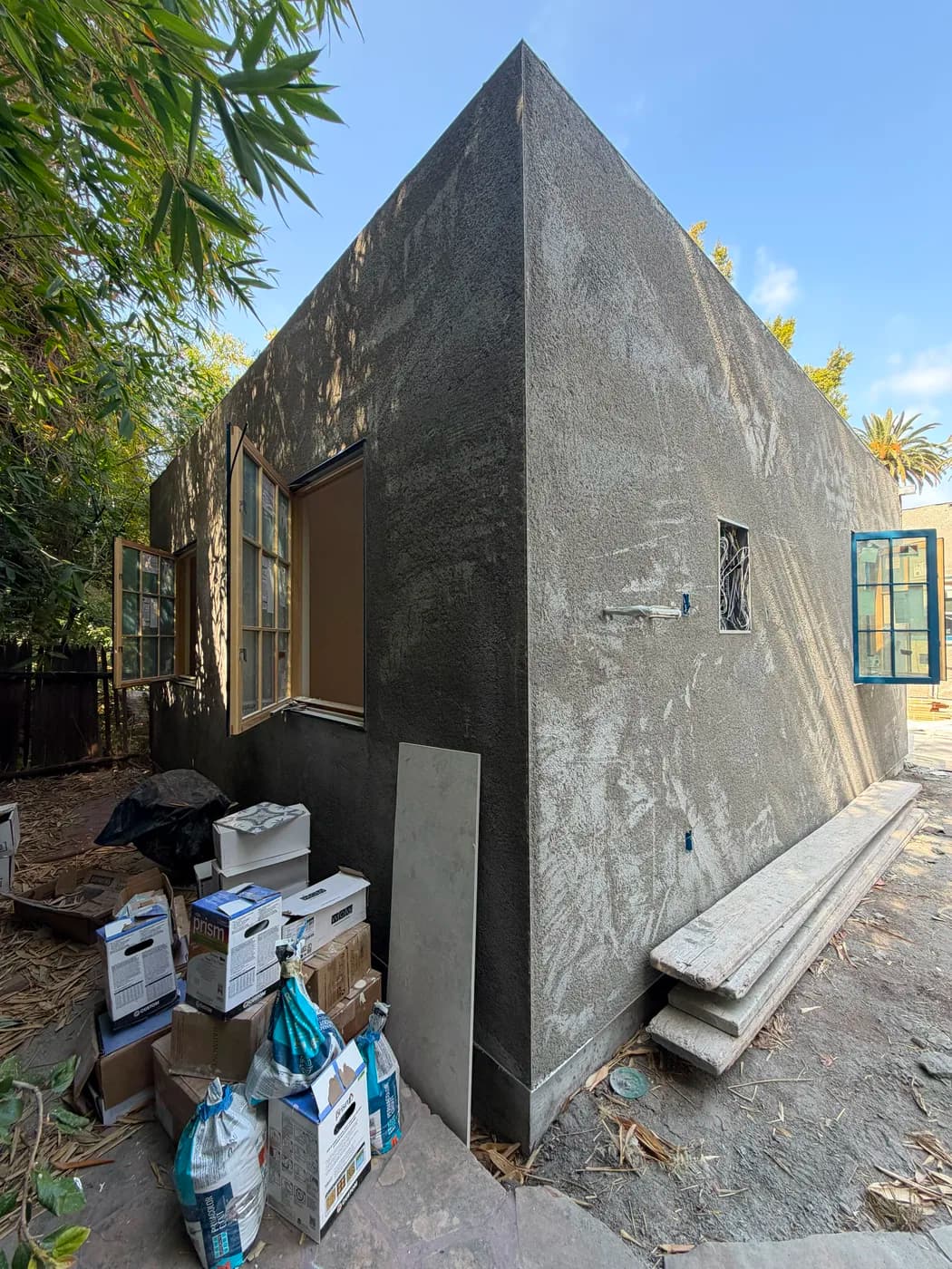Exterior stucco application in progress by Top Tech Builders