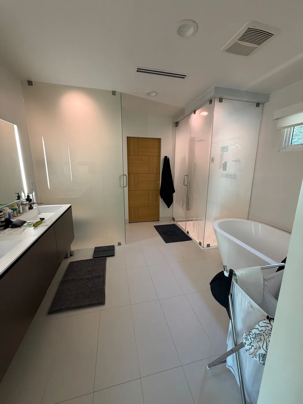 Freestanding tub and glass shower bathroom by Top Tech Builders