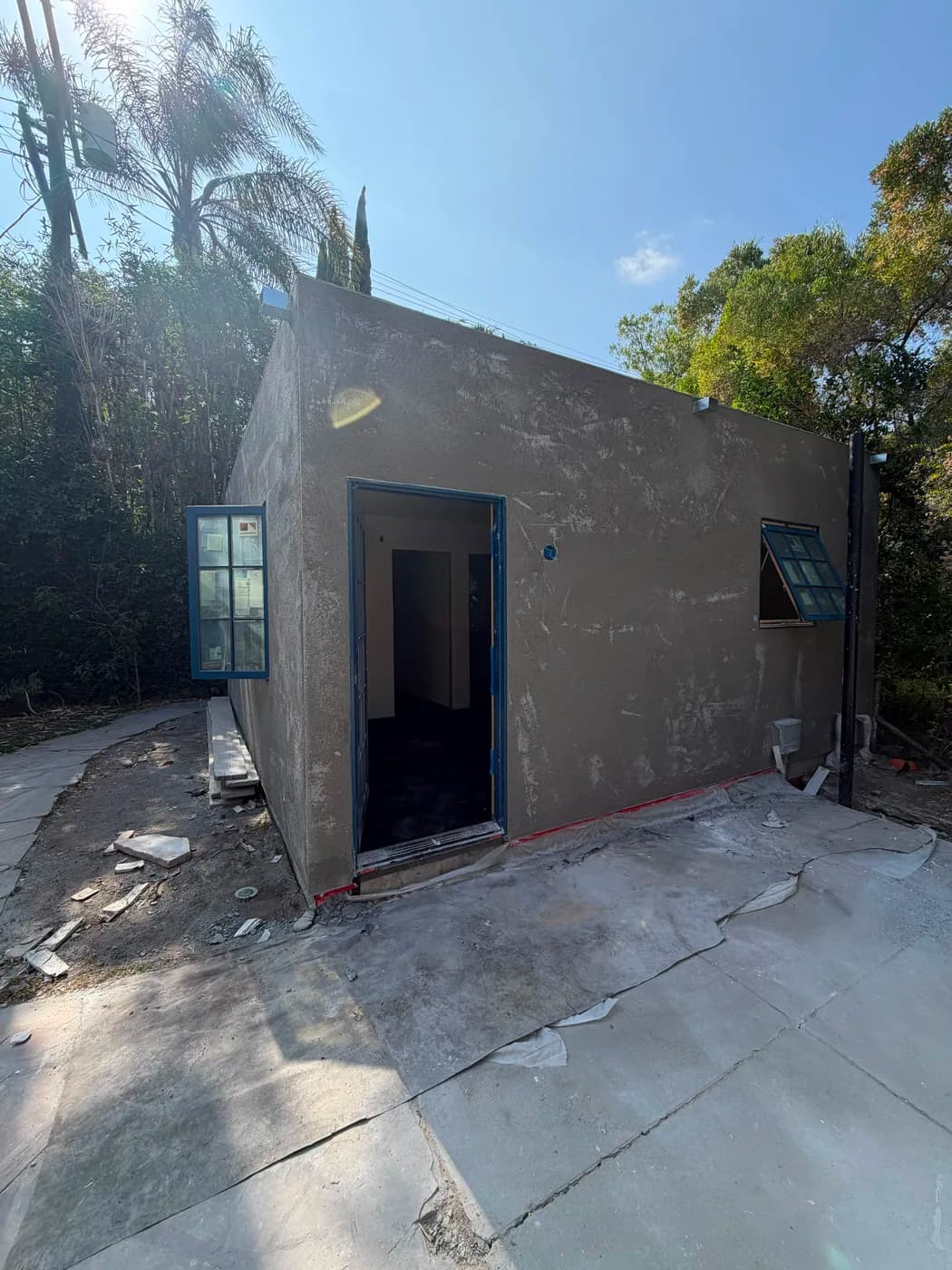 New stucco structure with entry door by Top Tech Builders
