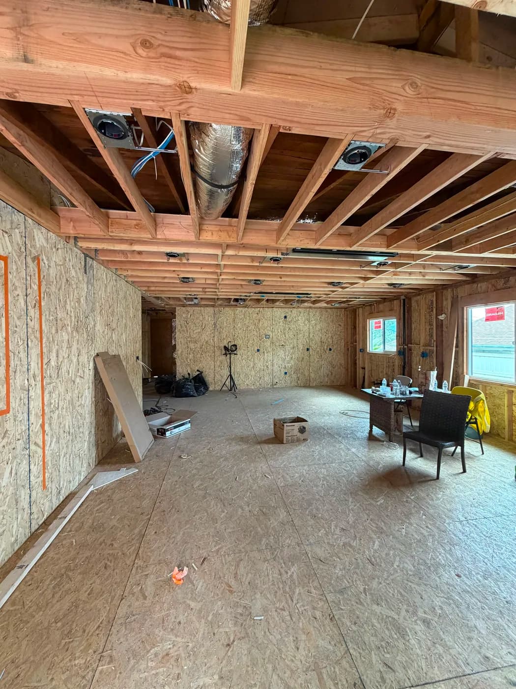 Open-concept living space framing by Top Tech Builders