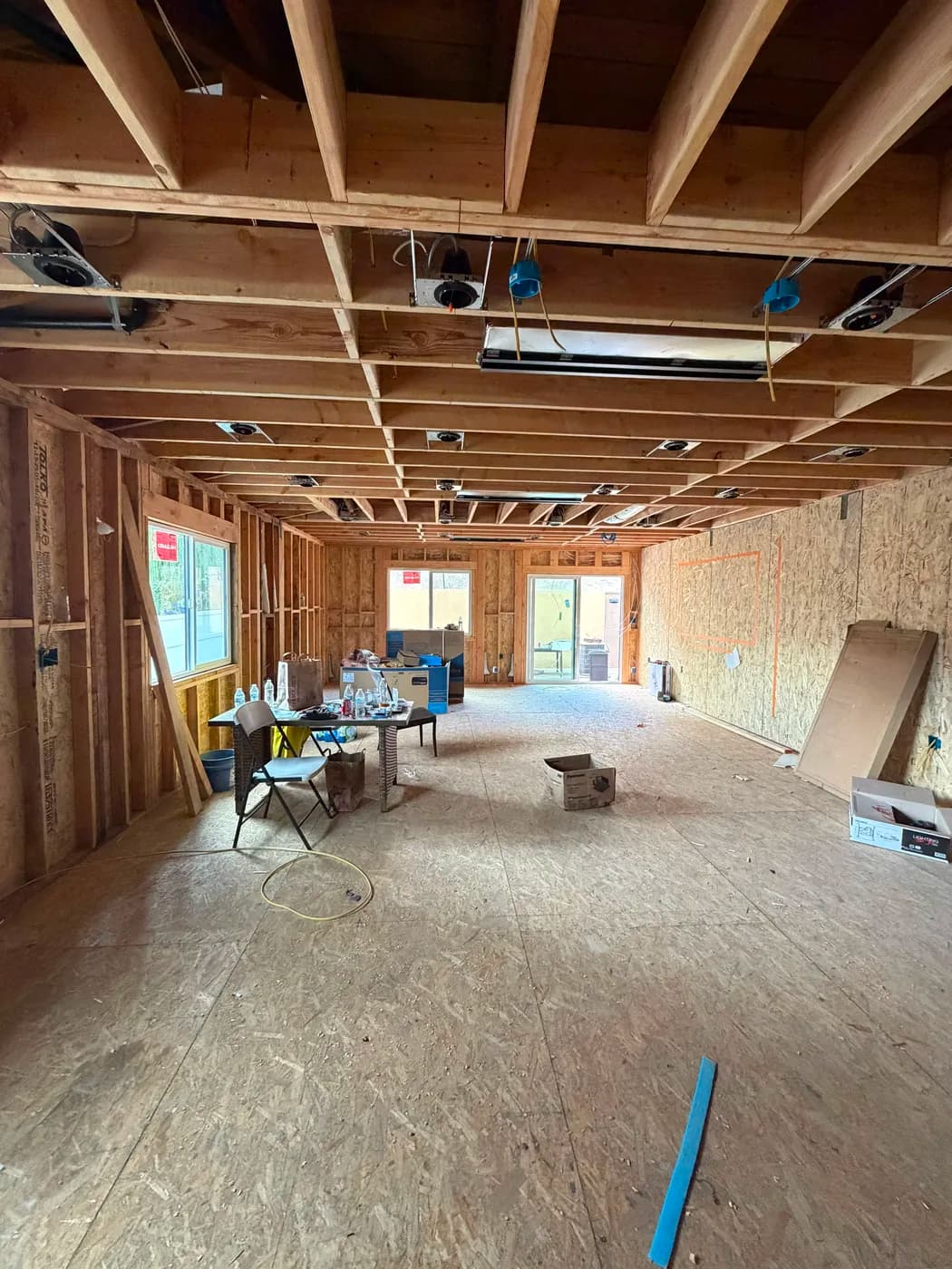 Open-concept living space with patio access by Top Tech Builders