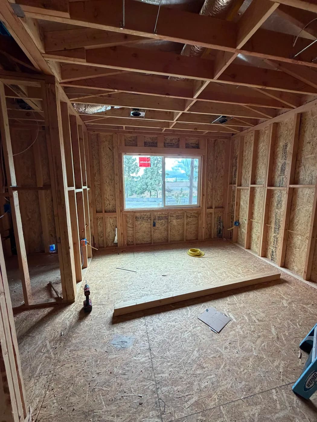 Bedroom framing with hillside view by Top Tech Builders