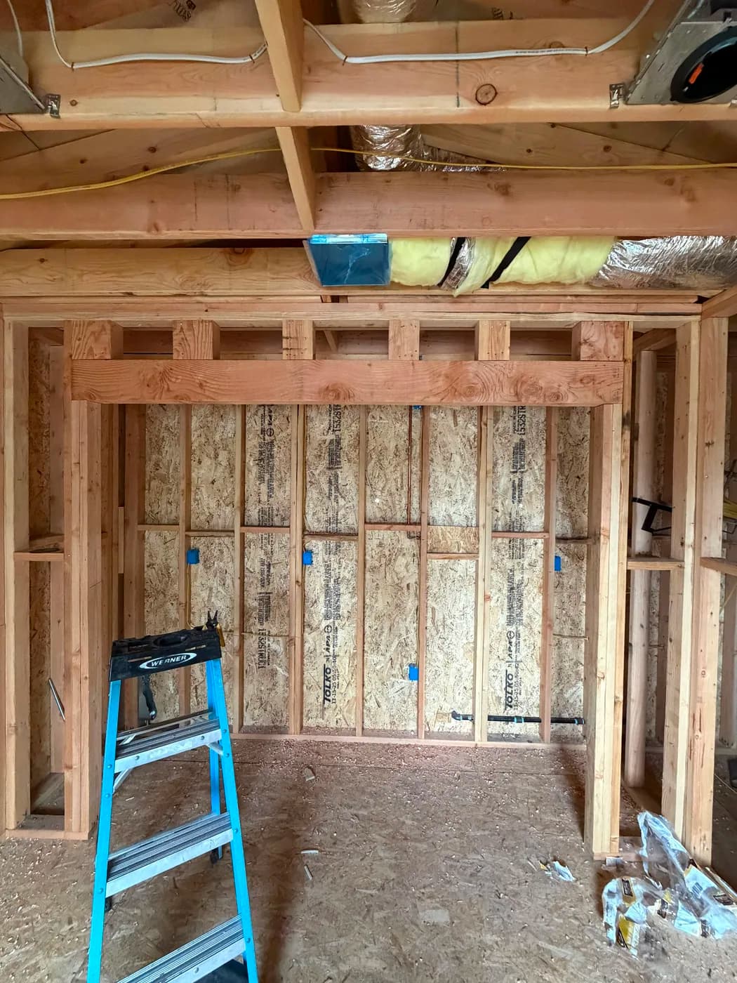 Framed closet interior with insulated ductwork by Top Tech Builders