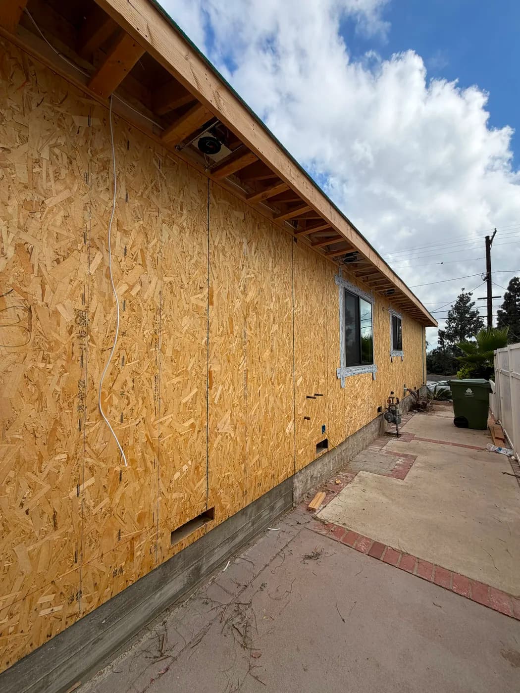 Exterior wall sheathing along home addition by Top Tech Builders