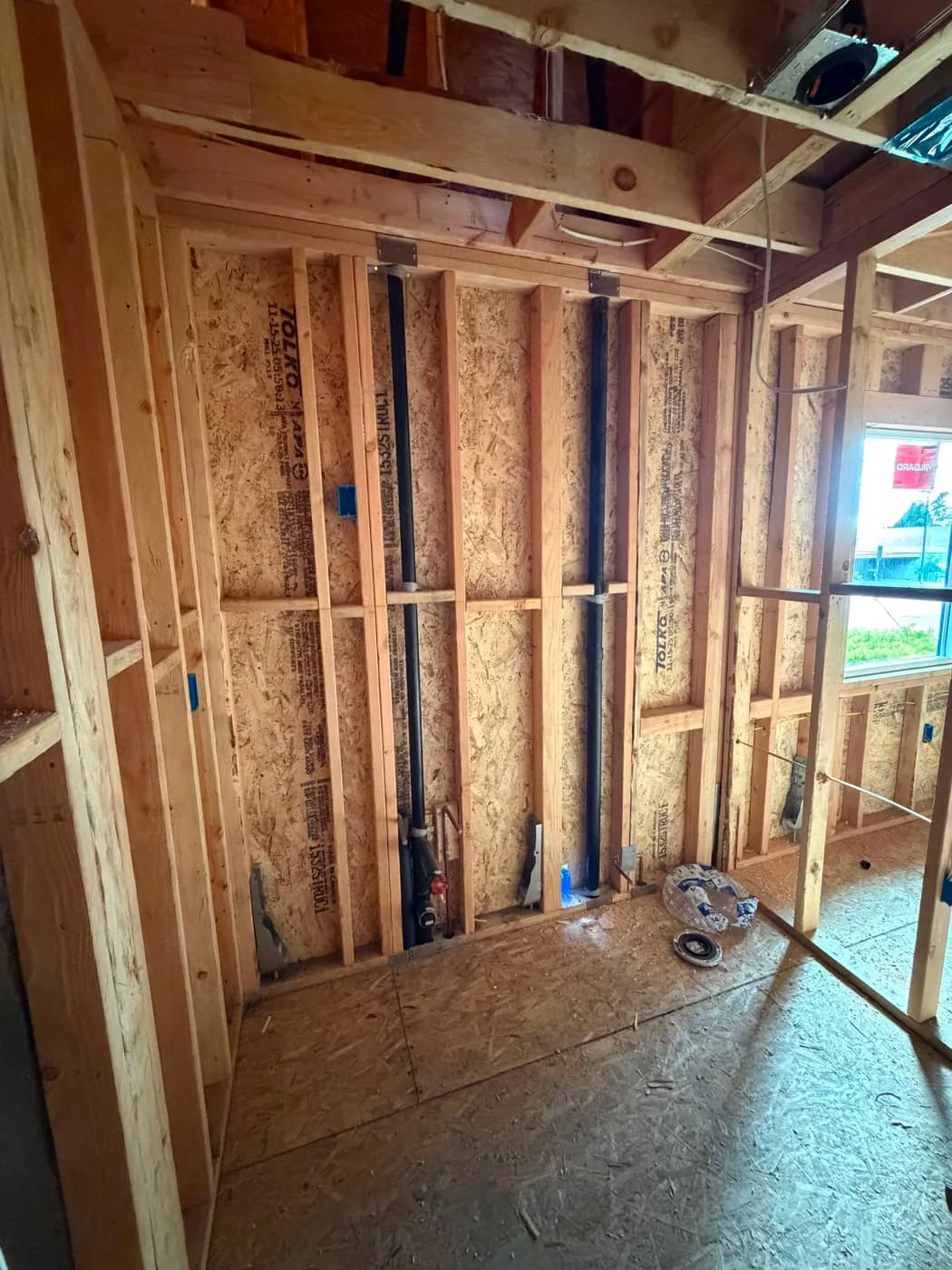 Interior wall framing with plumbing rough-in by Top Tech Builders