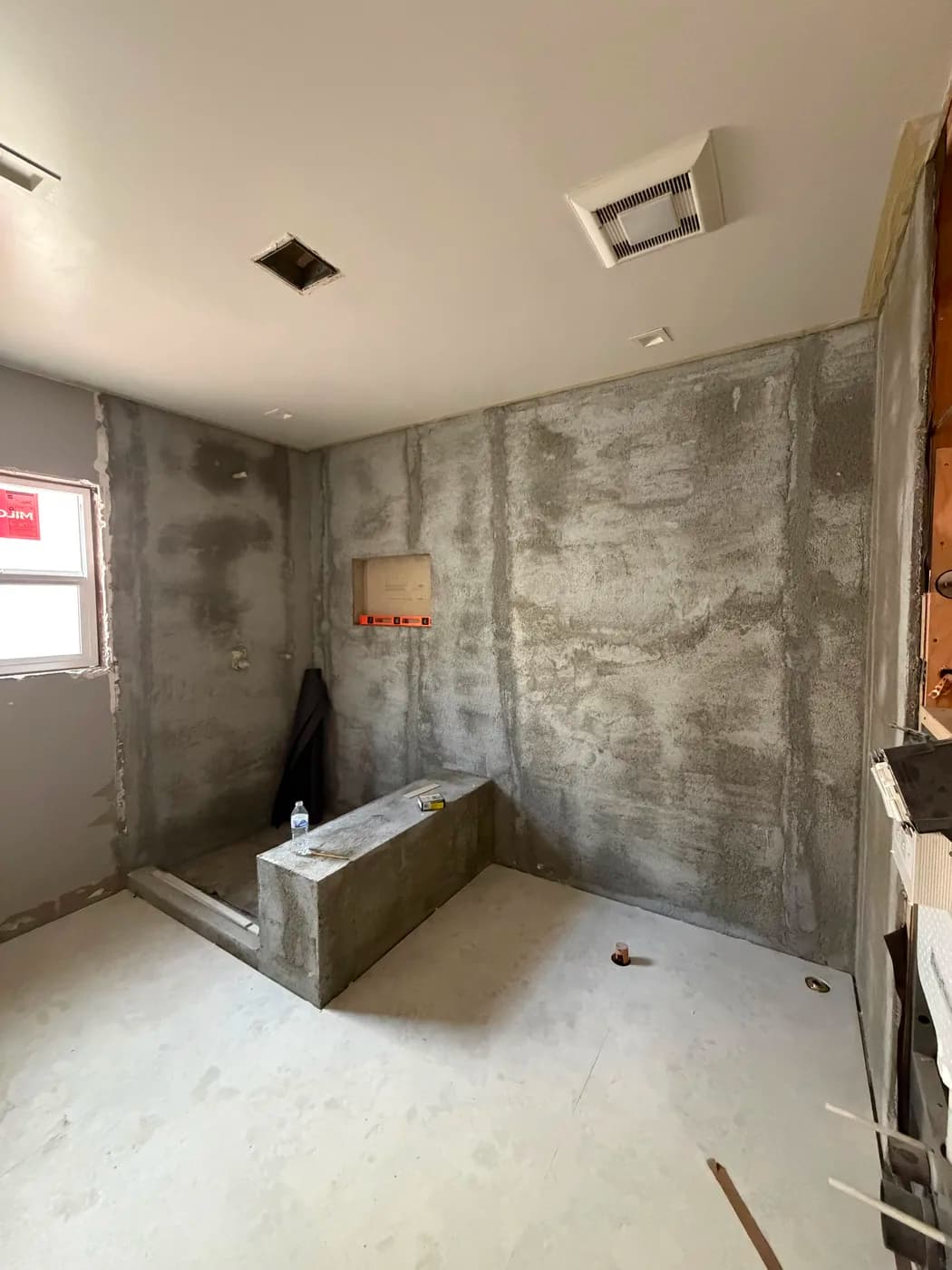 Bathroom shower pan and waterproofing in progress by Top Tech Builders