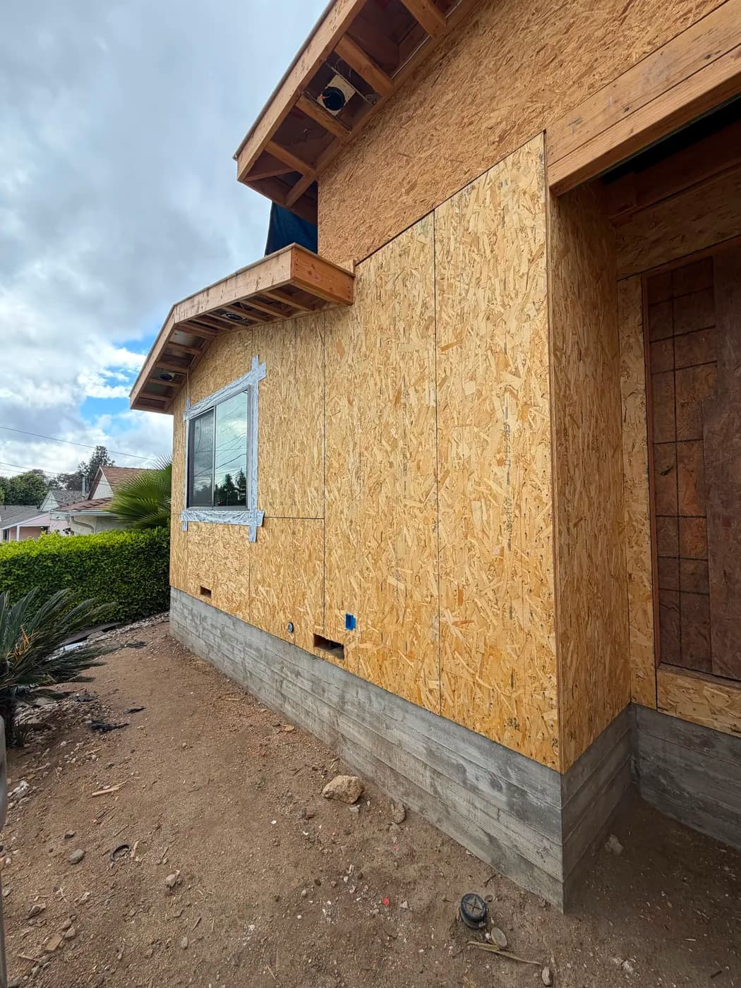 Exterior corner framing with window and door opening by Top Tech Builders