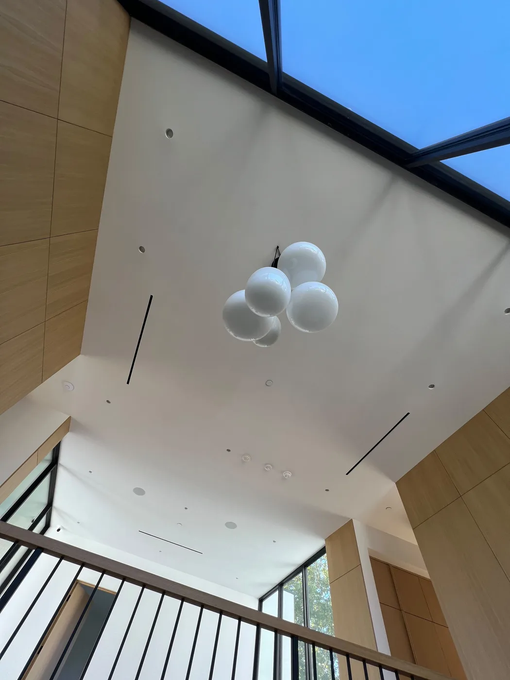 Vaulted ceiling with a skylight and a modern globe pendant light fixture